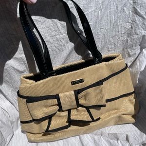 Authentic beige woven style Kate Spade with black trim and bow detail.